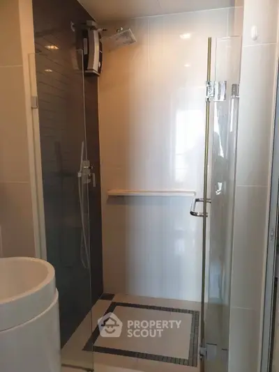 Modern bathroom with glass shower enclosure and sleek fixtures