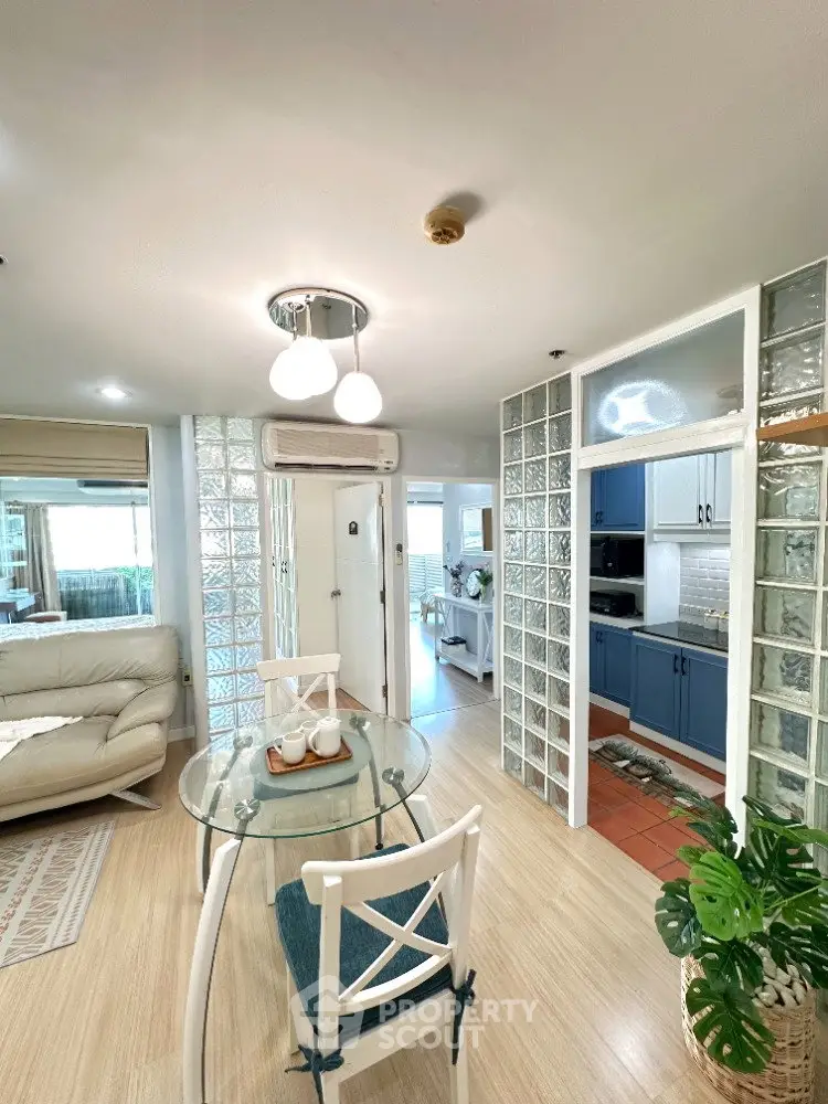 Stylish open-plan living room with glass brick accents and modern furnishings