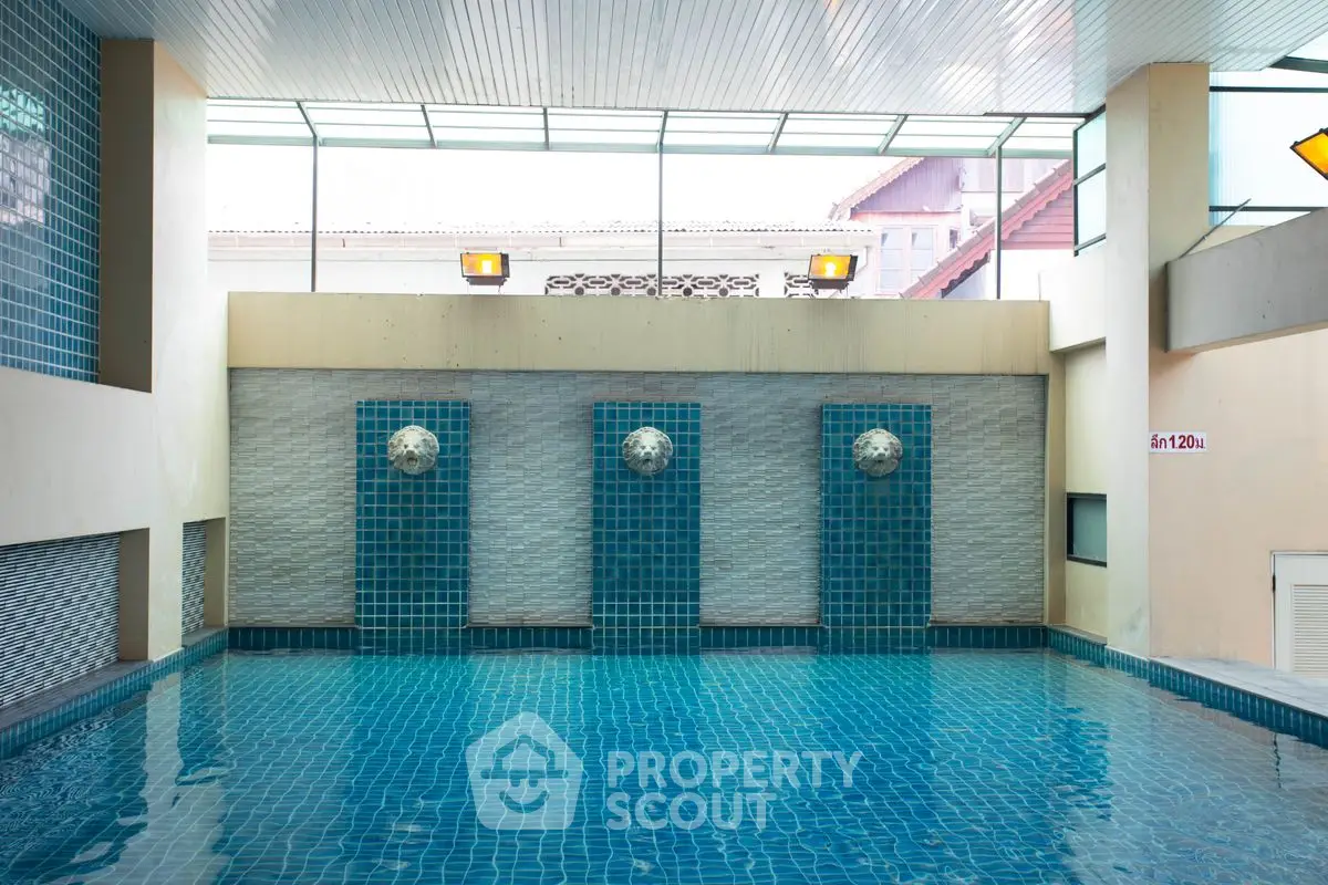 Luxurious indoor pool with modern design and vibrant blue tiles
