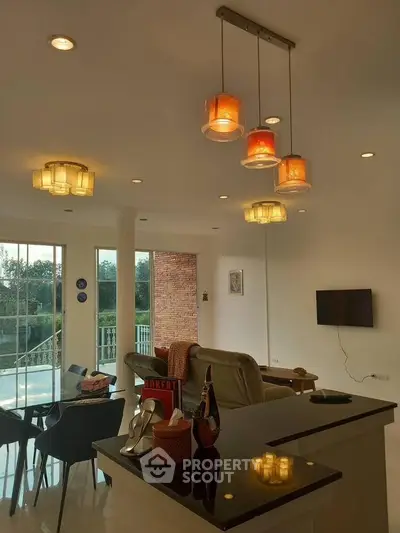 Stylish living room with modern lighting and open layout, featuring a scenic view through large windows.