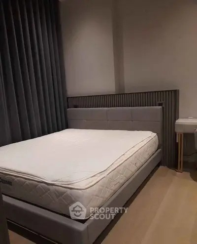 Modern bedroom with stylish bed and elegant decor in a cozy apartment.