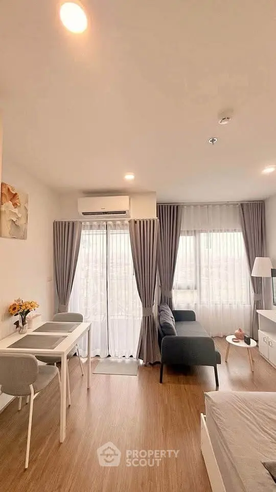 Modern living room with stylish furniture and large windows in a cozy apartment.