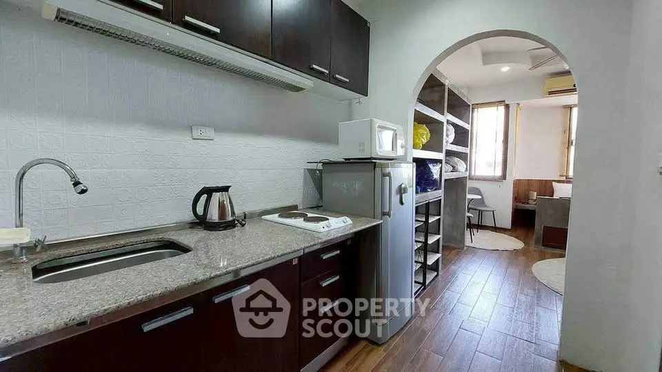 Charming kitchen with modern appliances and open layout leading to cozy dining area.