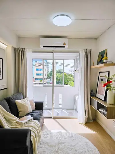 Bright living room with modern decor and balcony view in urban apartment