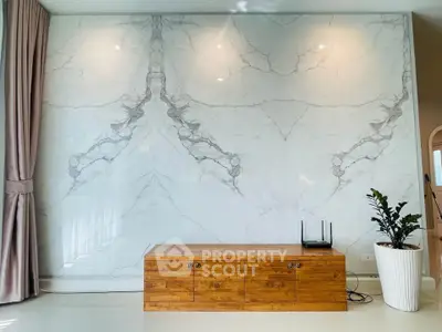 Elegant living room with marble accent wall and wooden console, perfect for modern interiors.