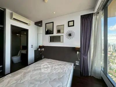 Modern bedroom with large window and city view, featuring stylish decor and air conditioning.