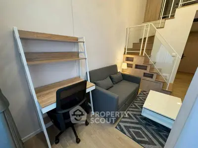 Modern loft-style living room with cozy sofa and study area