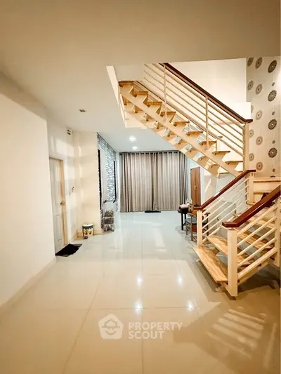 Spacious modern living area with elegant staircase and stylish decor
