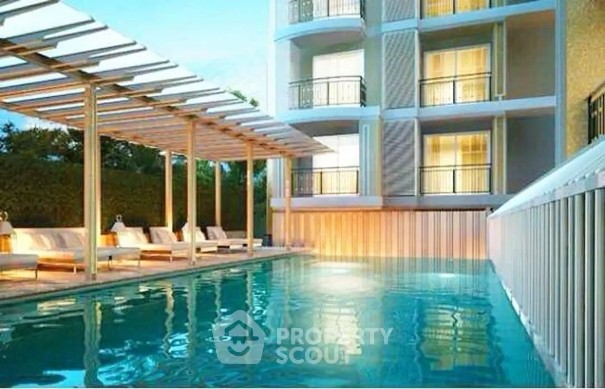 Luxurious apartment building with a stunning poolside view and elegant outdoor seating.