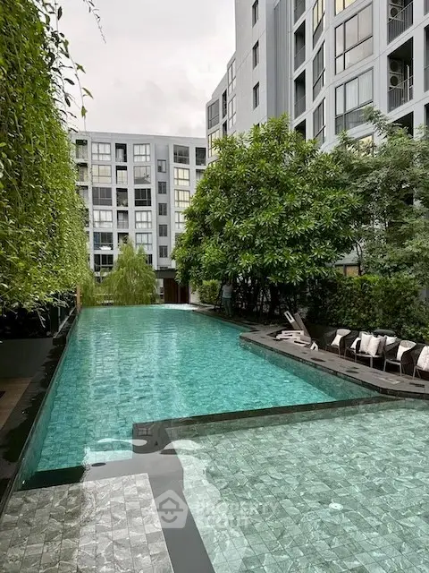 Luxurious condominium with stunning pool and lush greenery, perfect for relaxation and modern living.