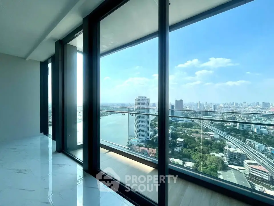 Stunning high-rise apartment with panoramic city and river views through floor-to-ceiling windows.
