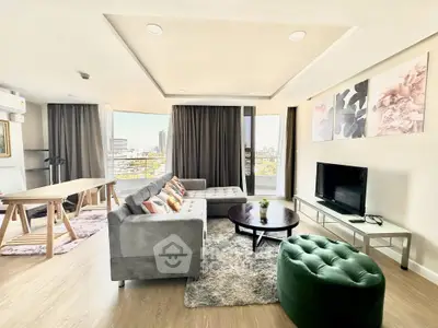 Spacious modern living room with city view, stylish decor, and ample natural light.