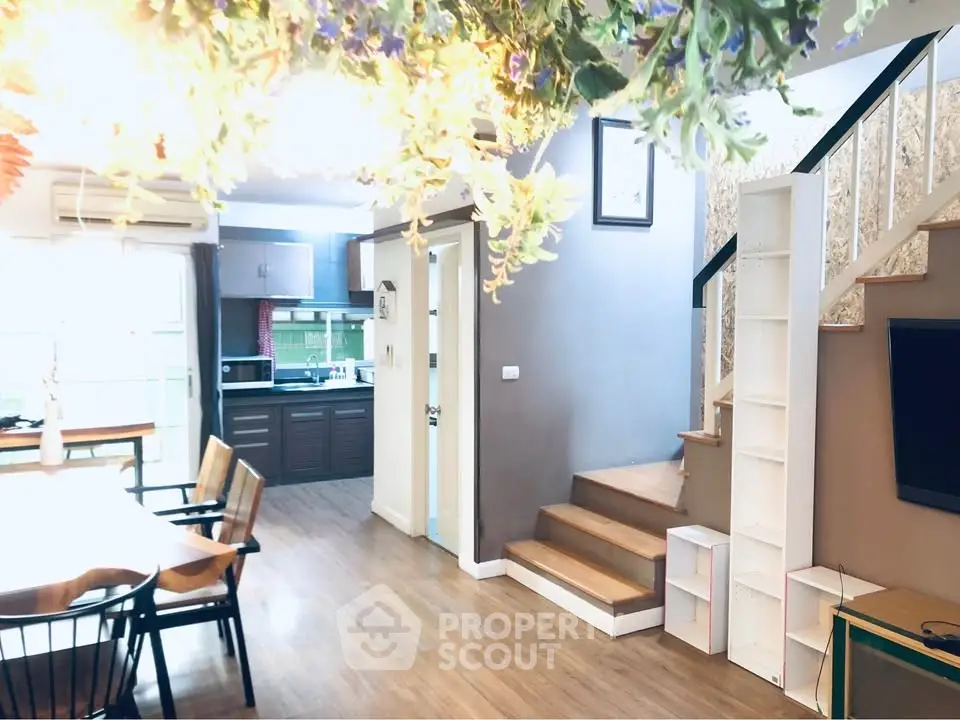 Charming open-plan living area with modern kitchen and stylish staircase