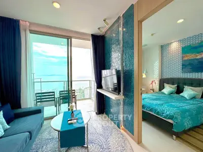 Luxurious ocean-view living room with modern decor and adjacent stylish bedroom