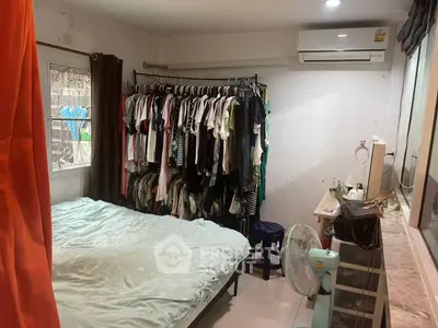 Cozy bedroom with air conditioning and ample closet space in a modern apartment.
