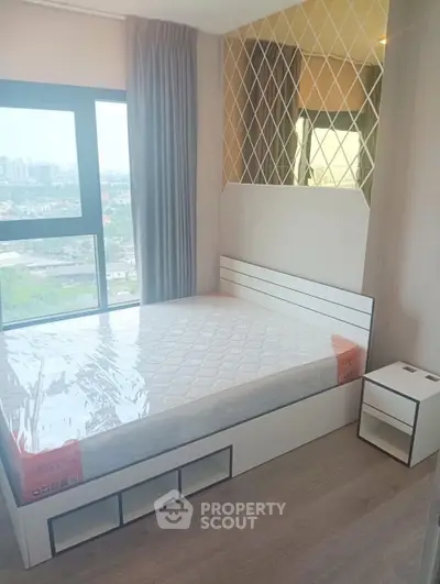 Modern bedroom with large window and stylish decor in high-rise apartment