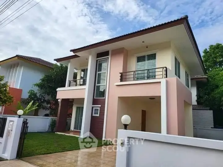 Charming two-story house with modern design and lush green lawn in a serene neighborhood.