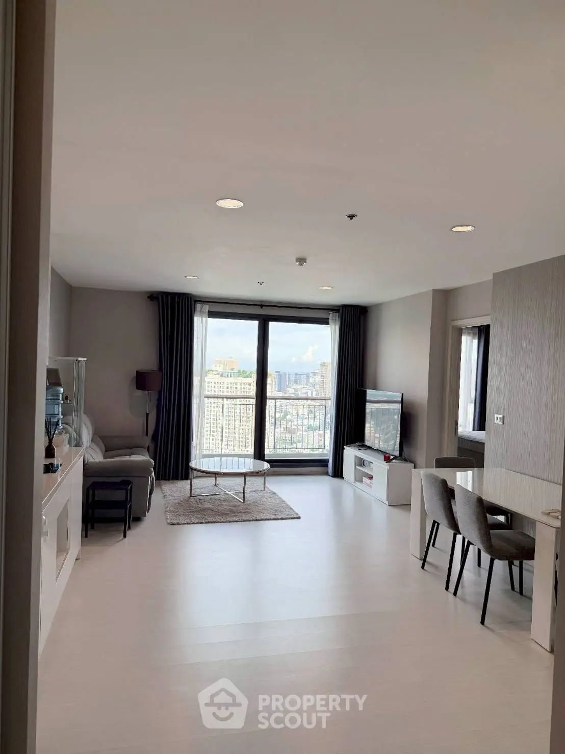 Spacious modern living room with city view and stylish furniture