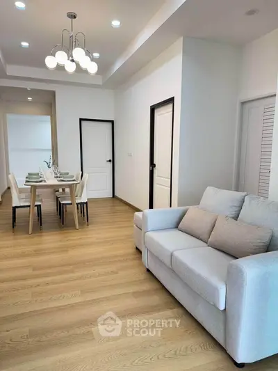 Modern living room with elegant dining area and stylish lighting