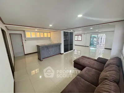 Spacious living room with modern open kitchen and cozy sectional sofa