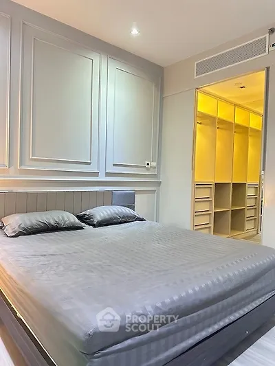 Luxurious bedroom with elegant paneling and spacious walk-in closet