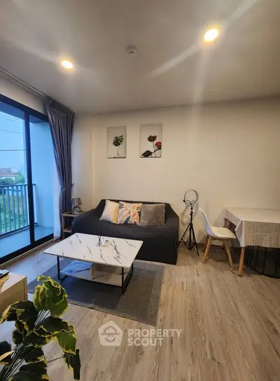 Modern living room with stylish decor and balcony view