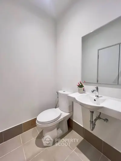 Modern minimalist bathroom with sleek fixtures and neutral tones.