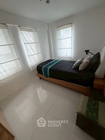 Cozy minimalist bedroom with natural light and modern decor