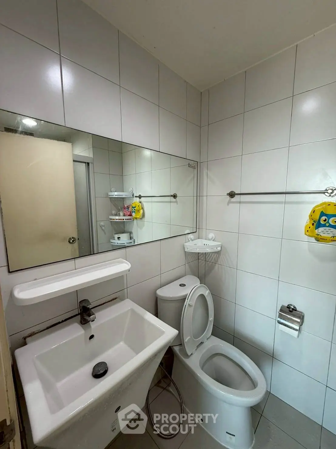 Compact bathroom with modern fixtures and white tile design.