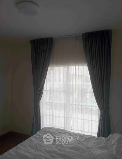 Cozy bedroom with elegant curtains and natural light