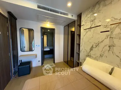 Modern bedroom with ensuite bathroom and stylish marble accent wall
