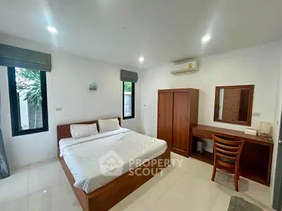 Modern bedroom with wooden furniture and natural light in a cozy home.