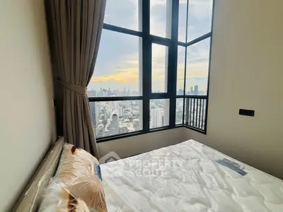 Stunning bedroom with panoramic city view and large windows, perfect for urban living.