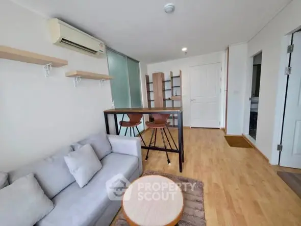 Modern living room with stylish furniture and wooden flooring in a cozy apartment.