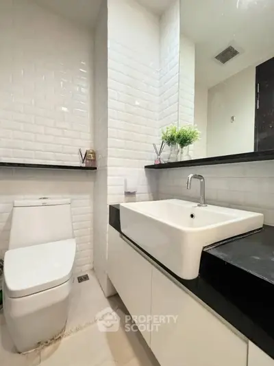 Modern bathroom with sleek white tiles and contemporary fixtures
