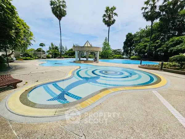 Luxurious outdoor pool area with lush greenery and palm trees, perfect for relaxation and leisure.