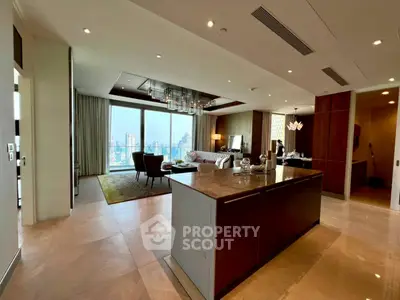 Luxurious open-plan living room with stunning city view and modern kitchen island.