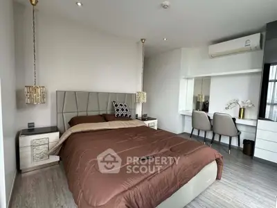 Luxurious modern bedroom with elegant decor and workspace