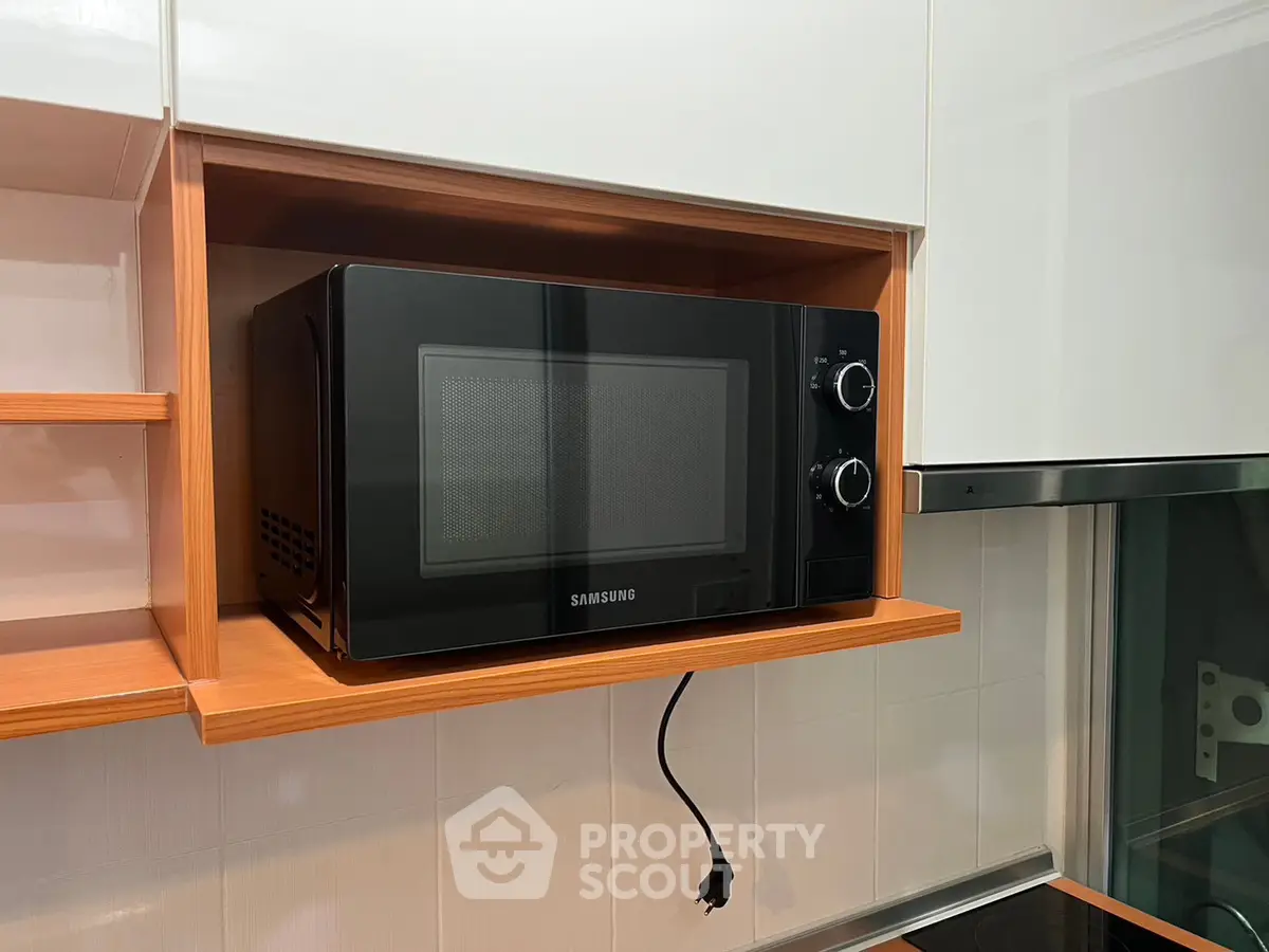 Modern kitchen with built-in microwave and sleek cabinetry