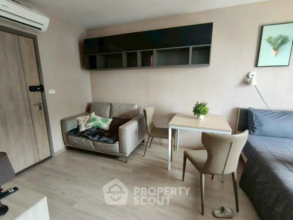 Cozy living room with modern furniture and wall-mounted storage in a stylish apartment.