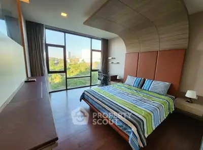 Spacious bedroom with large windows and modern decor