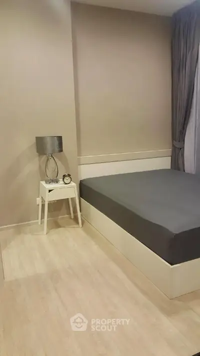 Modern minimalist bedroom with sleek design and neutral tones.
