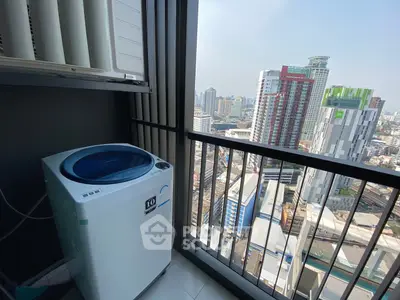 High-rise apartment balcony with washing machine and stunning city view.