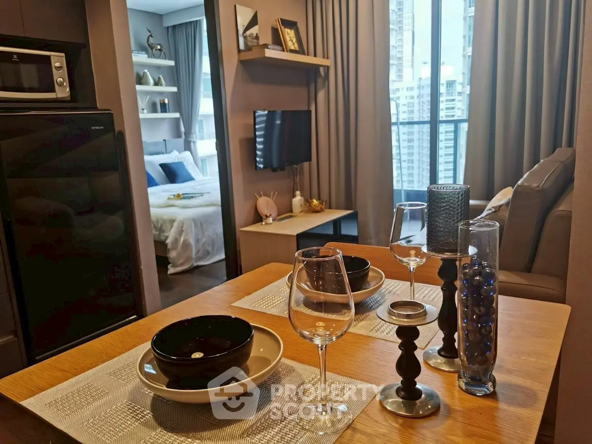 Modern apartment interior with stylish dining area and cozy bedroom view.