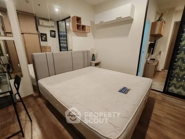 Modern bedroom with stylish decor and spacious layout, featuring a comfortable bed and wooden flooring.