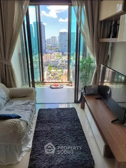 Modern living room with stunning city view through large windows, cozy seating, and sleek TV setup.