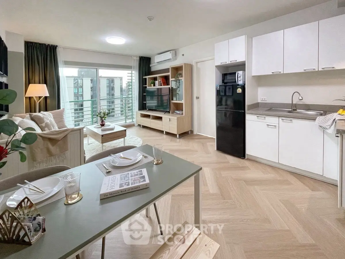 Modern open-plan living room and kitchen with stylish decor and balcony view.