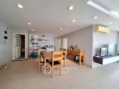Spacious open-plan living room with dining area and modern decor