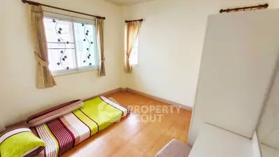 Cozy minimalist bedroom with floor mattress and natural light