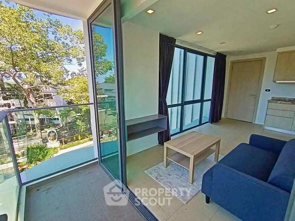 Modern living room with large windows and balcony view in a stylish apartment